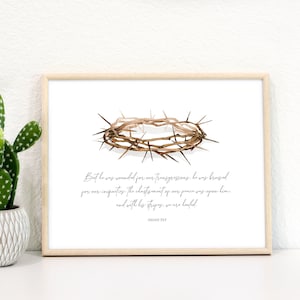 May include: A framed print with a watercolor illustration of a crown of thorns. The print includes a quote from Isaiah 53:3: "But he was wounded for our transgressions, he was bruised for our iniquities: the chastisement of our peace was upon him; and with his stripes we are healed."