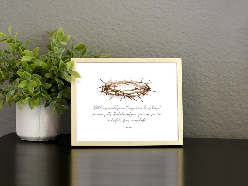 May include: A printable art print with a watercolor illustration of a crown of thorns. The print features a quote from Isaiah 53:5: "But he was wounded for our transgressions, he was bruised for our iniquities: the chastisement of our peace was upon him; and with his stripes we are healed."