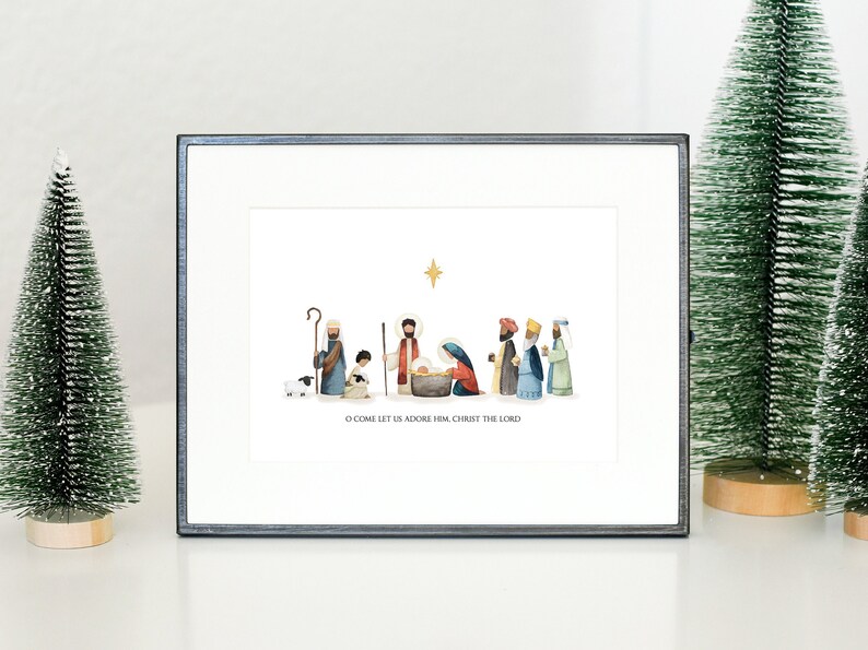 May include: A framed print of a watercolor illustration depicting the nativity scene. The illustration features a star, a manger, a baby Jesus, Mary, Joseph, and several other figures. The text below the illustration reads "O come let us adore Him, Christ the Lord."