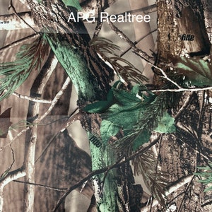 May include: Camouflage fabric with a realistic forest pattern. The design features brown tree bark, green leaves, and branches. The text "APG Realtree" is visible in white. This fabric is suitable for hunting and outdoor apparel.