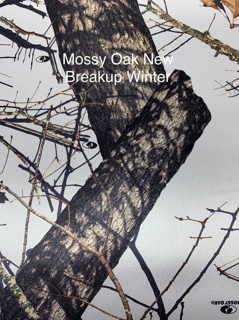 May include: A close-up of a camouflage pattern with the text "Mossy Oak New Breakup Winter". The pattern features a mix of brown, gray, and white, resembling tree bark and branches. The design is suitable for outdoor activities.