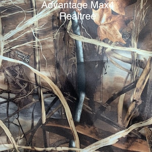 May include: Camouflage fabric featuring a blend of brown, tan, and green hues, with a pattern of leaves, branches, and other natural elements. The text "Advantage Max4 Realtree" is visible on the fabric. This design is commonly used for hunting and outdoor apparel.