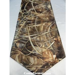 May include: A brown, beige, and green camouflage table runner with a leafy pattern. The runner has a pointed end and is made of a satin-like fabric.