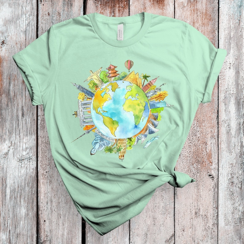 May include: A light green t-shirt with a watercolor illustration of the Earth surrounded by famous landmarks from around the world.