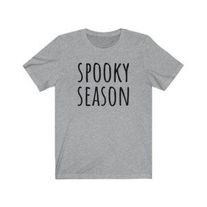 May include: A heather gray t-shirt with the text "SPOOKY SEASON" printed in black.