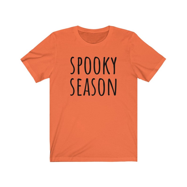 May include: Orange short-sleeved t-shirt with the text "SPOOKY SEASON" printed in black.
