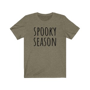 May include: A green t-shirt with the text "Spooky Season" in black.