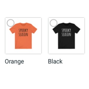 May include: Two t-shirts with the text "Spooky Season" printed on them. The t-shirt on the left is orange and the t-shirt on the right is black.
