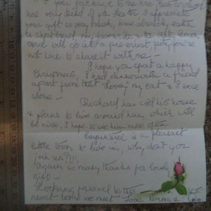 May include: A handwritten letter with a pink rose illustration and the text "Warning January 1987 a really happy New Year". The letter is written in blue ink and expresses gratitude for a gift and wishes the recipient a happy Christmas.