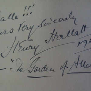 May include: Black and white handwritten signature with the text "Inshallah!! Yours very sincerely,  Henry Hallatt 1921. "The Garden of Allah"