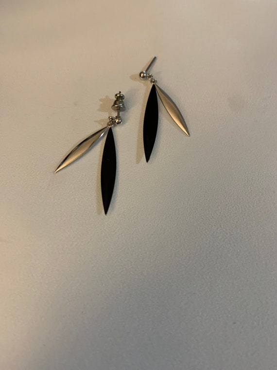 The dainty black and silver earrings.
