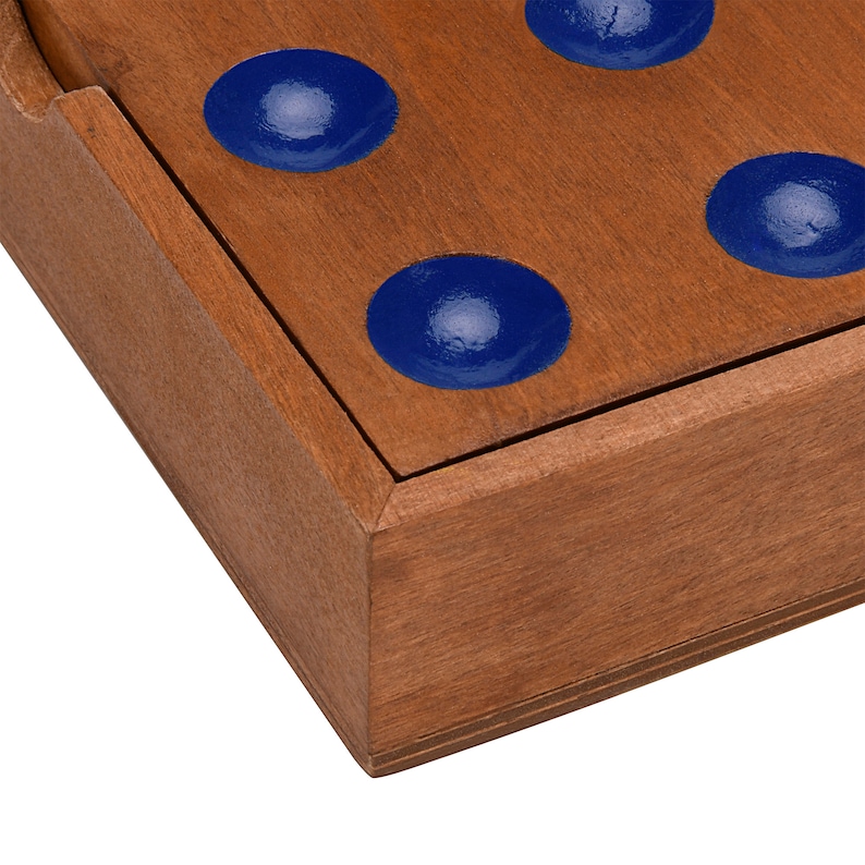 May include: A wooden game board with blue painted circles. The board is made of dark wood and has a raised edge.