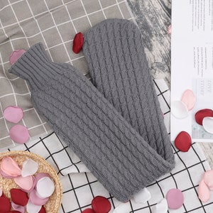 Extra long hot water bottle with knitted cover and interchangeable cover for the neck and back