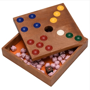 May include: A wooden game board with a hole in the center and colored pegs in the corners. The board is open and the lid is off, revealing a compartment filled with small pink pig figurines.