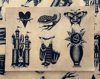 May include: A sheet of paper with black and white traditional tattoo flash designs. The designs include a heart with barbed wire, a snake, a bat, a castle, a butterfly, and a rose in a vase.