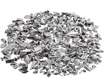 May include: A pile of irregularly shaped, dark gray shungite stones. The stones have a reflective, metallic appearance and vary in size. The background is plain white, highlighting the texture and color of the stones. The image is well-lit, showcasing the natural variations in the shungite.
