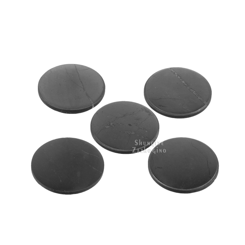 May include: Five round, dark gray coasters with subtle veining. The coasters are made of a solid material and have a smooth surface. The coasters are arranged in a scattered pattern. The coasters are suitable for use with glasses and mugs.