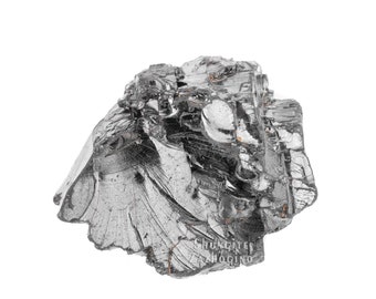May include: A large, dark gray, metallic, irregularly shaped chunk of shungite. The shungite has a rough, textured surface and is a natural mineral.