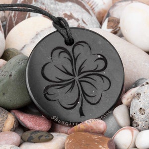 Various Shungite pendants engraved amulets Choose your own Nine different styles Size 1.4 inches Authentic Russian shungite stone Four-leaf clover