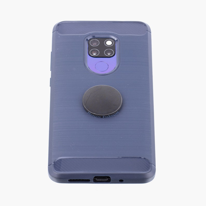 May include: A navy blue phone case with a textured back and a black circular phone grip attached. The case has a camera cutout and a port at the bottom. The phone grip has the text "Shanghai Lazhocks".