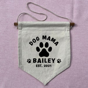 May include: A white canvas banner with black text and a paw print. The text reads "Dog Mama Bailey Est. 2021".