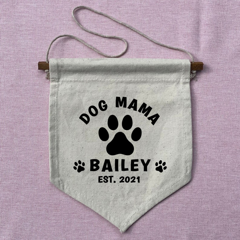 May include: A white canvas banner with black text and a paw print. The text reads "Dog Mama Bailey Est. 2021".