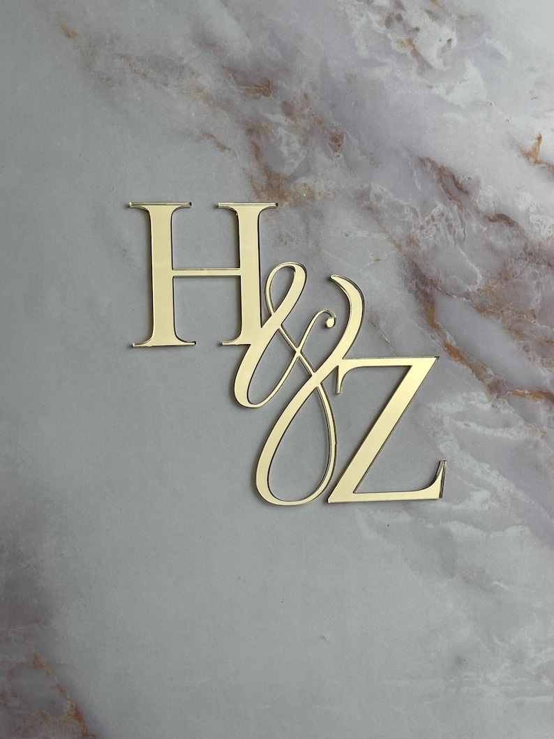 May include: Gold-colored metal initials "H & Z" with a decorative script font for the "Z".