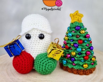 May include: Crocheted Christmas decorations including a white ghost, a green Christmas tree with colorful bells, and red and gold gift boxes.
