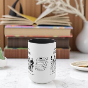 Pu&ograve; includere: Una tazza in ceramica bianca con un bordo nero. La tazza presenta un'illustrazione in bianco e nero di personaggi dei romanzi di Jane Austen. Il testo "Jane Austen's Bad Boys!" &egrave; stampato sulla tazza.