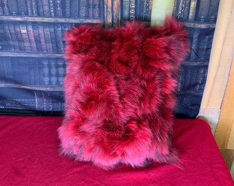 Decorative cushion in recycled fox fur sewn in red strips