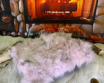 Decorative cushion in recycled fox fur sewn in small pieces in pink patchwork style