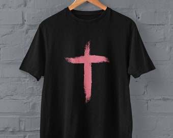 May include: Black t-shirt with a pink painted cross design.