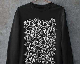 May include: Black sweatshirt with a white graphic print of multiple stylized eyes.