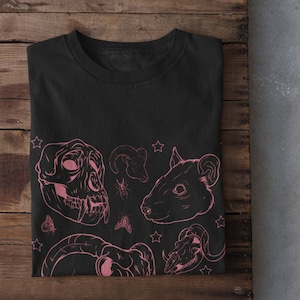May include: Black t-shirt with a pink graphic print of animal skulls, insects, and stars.