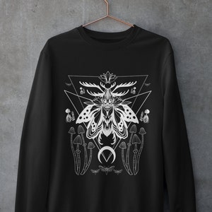 May include: Black sweatshirt with a white graphic design of a moth with antlers, mushrooms, and a crescent moon. The design is surrounded by a triangle.