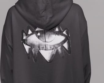 May include: A black hooded sweatshirt with a white graphic of an eye on the back.