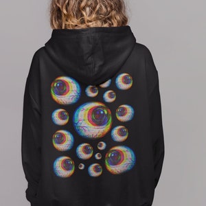 May include: Black hoodie with a graphic print of multiple colorful eyes on the back.