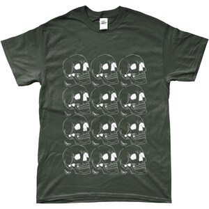 May include: A dark green t-shirt with a white skull pattern. The skulls are arranged in a grid pattern and are repeated throughout the shirt.