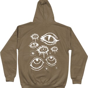 May include: A brown hooded sweatshirt with a white graphic print of multiple eyes on the back.