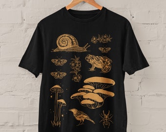 May include: Black t-shirt with a gold print of a snail, mushrooms, a frog, a crow, a beetle, and butterflies.