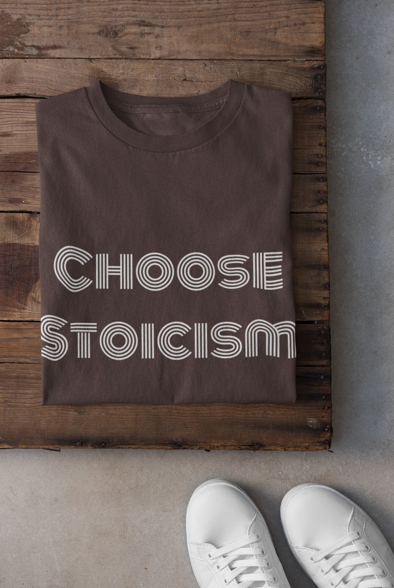 May include: A brown t-shirt with the text "CHOOSE STOICISM" printed in white with a retro font.