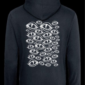 May include: A dark blue hooded sweatshirt with a white print of multiple stylized eyes on the back.