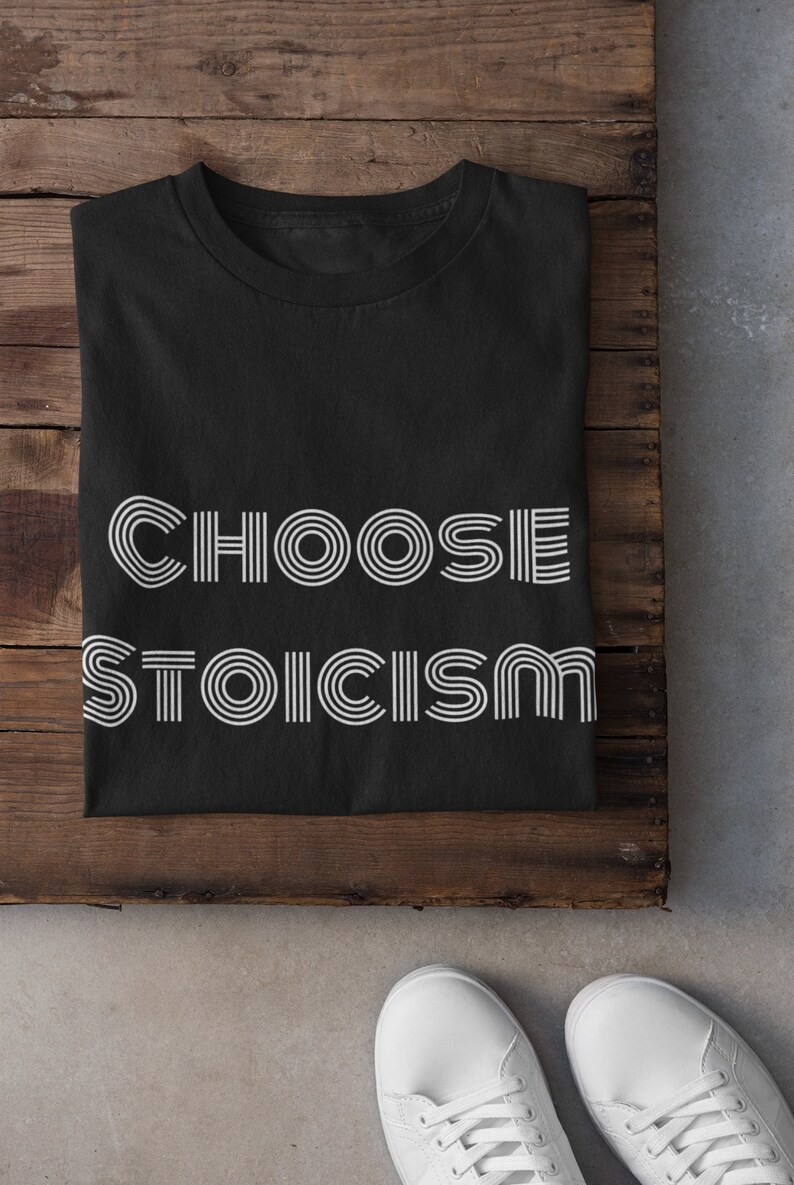 May include: Black t-shirt with white text that reads "CHOOSE STOICISM" in a retro font style.