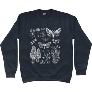 K&ouml;nnte beinhalten: Ein dunkelblaues Sweatshirt mit einem wei&szlig;en Druck verschiedener Insekten, Pilze und Pflanzen. Der Druck beinhaltet eine Spinne, eine Libelle, einen Nachtfalter und verschiedene Pilzarten.