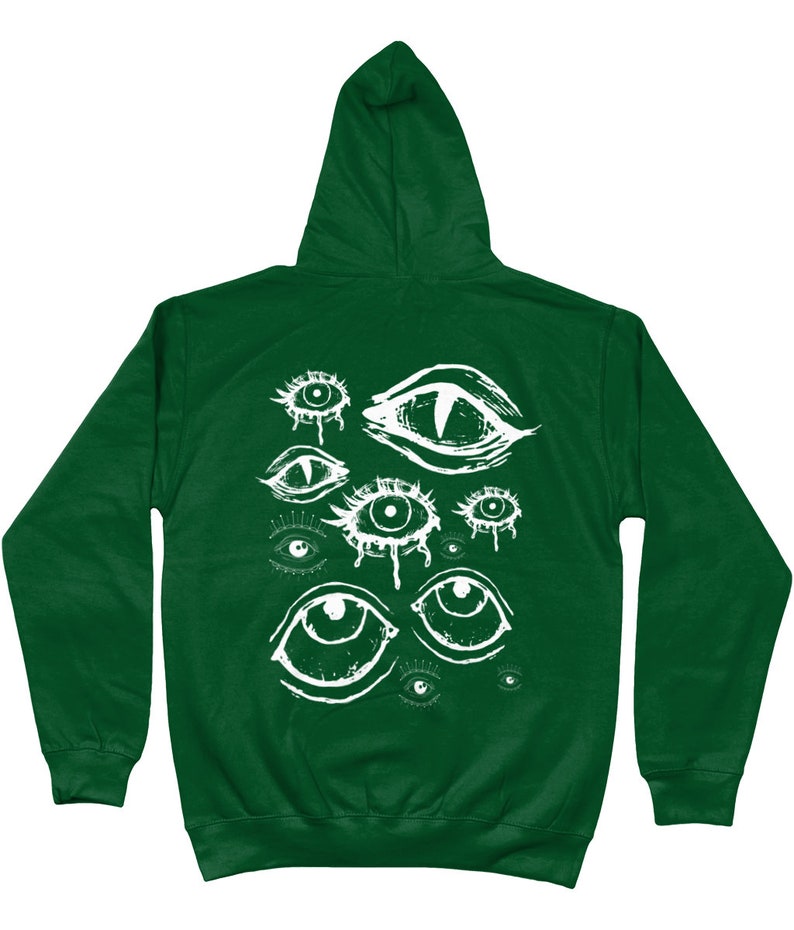 May include: A dark green hooded sweatshirt with a white graphic print of multiple stylized eyes. The eyes are drawn in a creepy, abstract style.