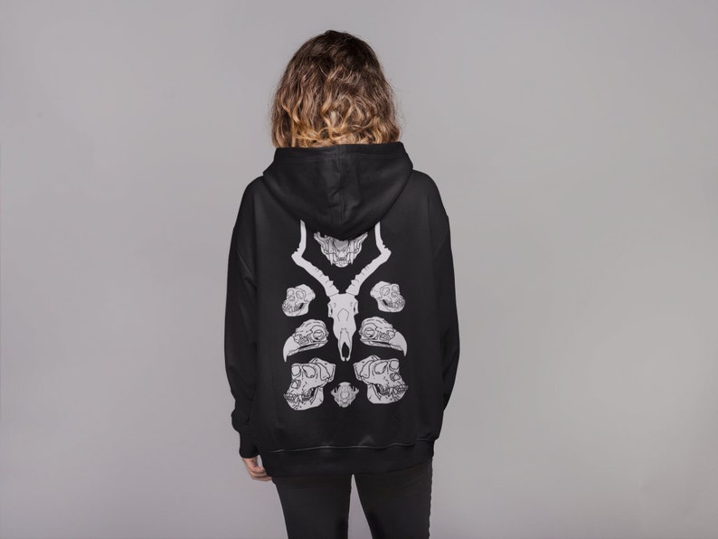 May include: Black hoodie with a white graphic print of animal skulls on the back.