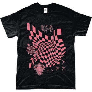 May include: Black t-shirt featuring a pink checkered pattern, a pink graphic of three figures, and pink hummingbirds.