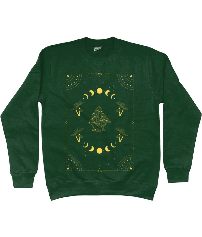 May include: A dark green sweatshirt with a yellow graphic design featuring mushrooms, moons, and stars. The design is framed by a geometric border.