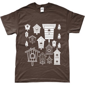 May include: A brown t-shirt featuring a white design of various birdhouses in different shapes and sizes.