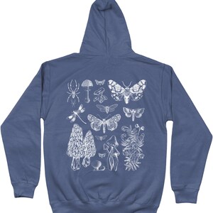 May include: A navy blue hooded sweatshirt with a white print of various insects, mushrooms, and plants. The print includes a spider, dragonfly, moths, mushrooms, and a floral design.